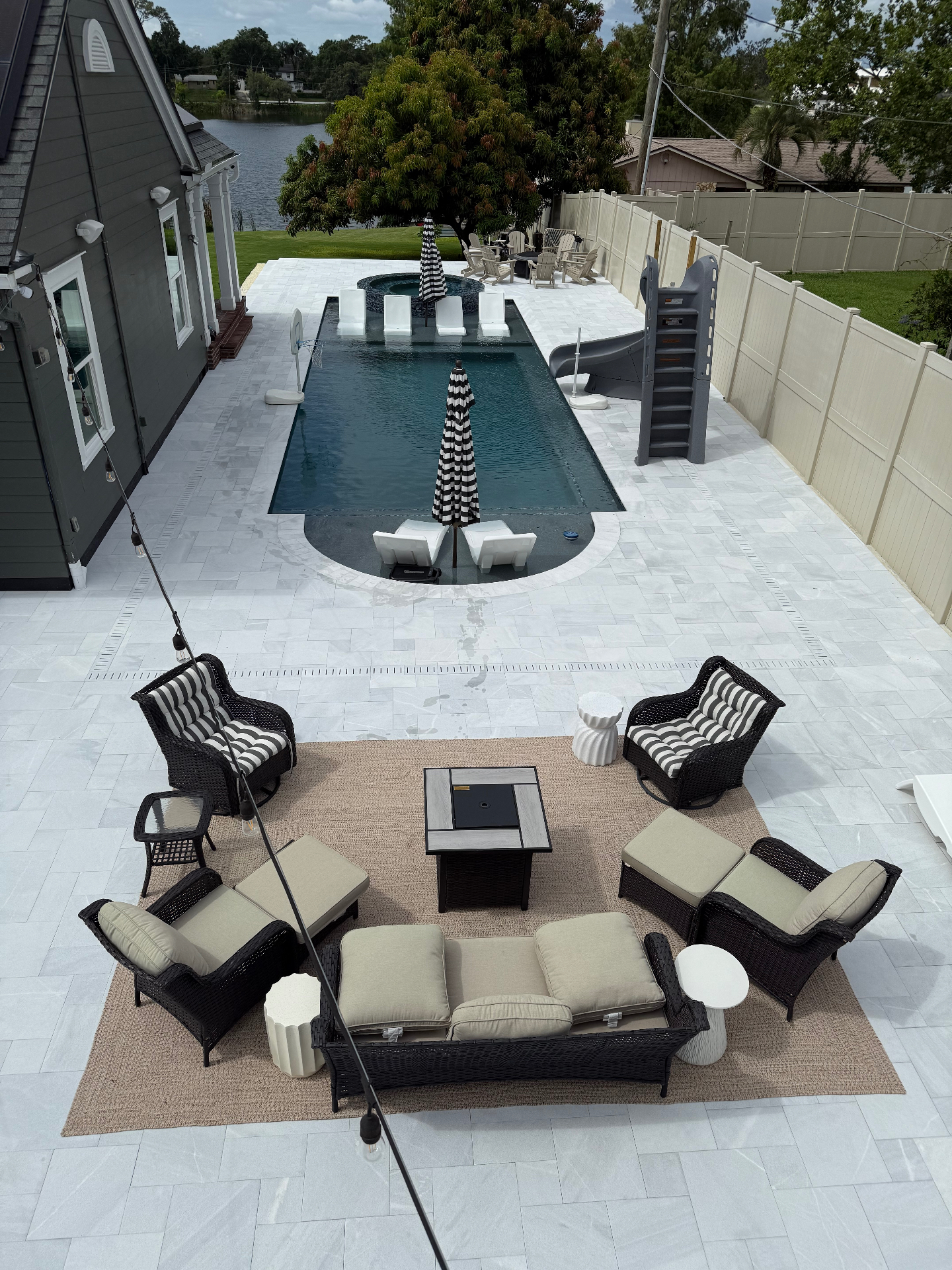 Elevated view of the Berry House pool, spa and lounge terrace with the lake beyond