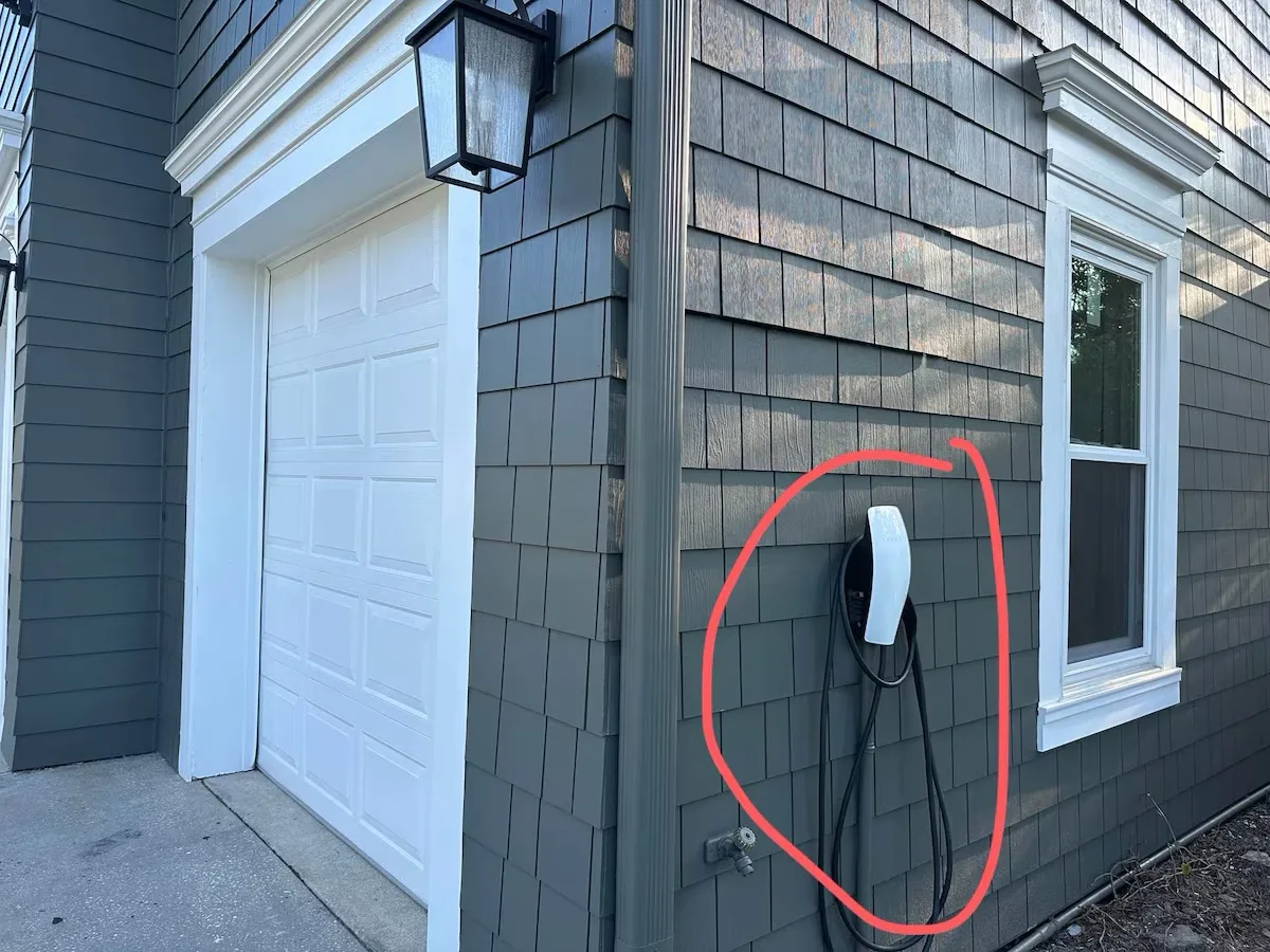Level 2 EV charger mounted beside the garage