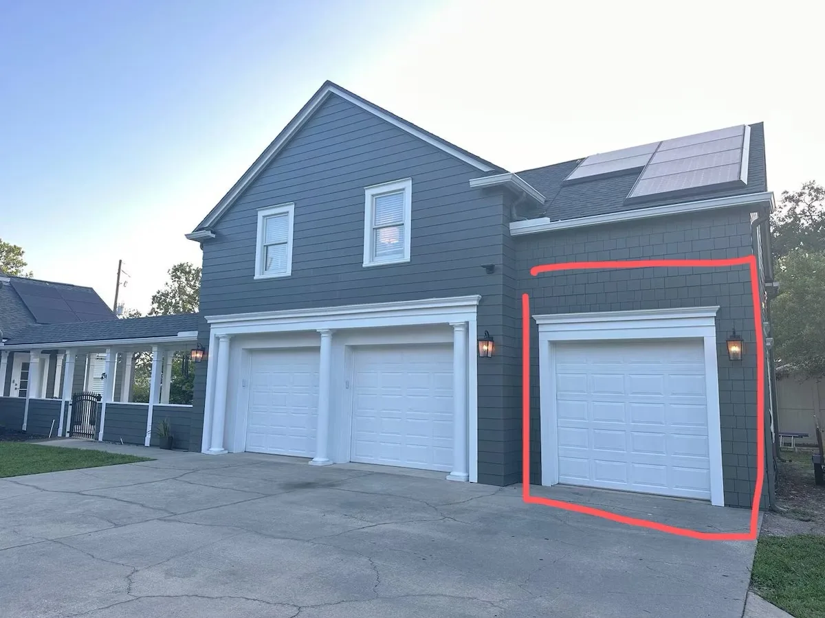 Garage and driveway showing the dedicated guest parking space
