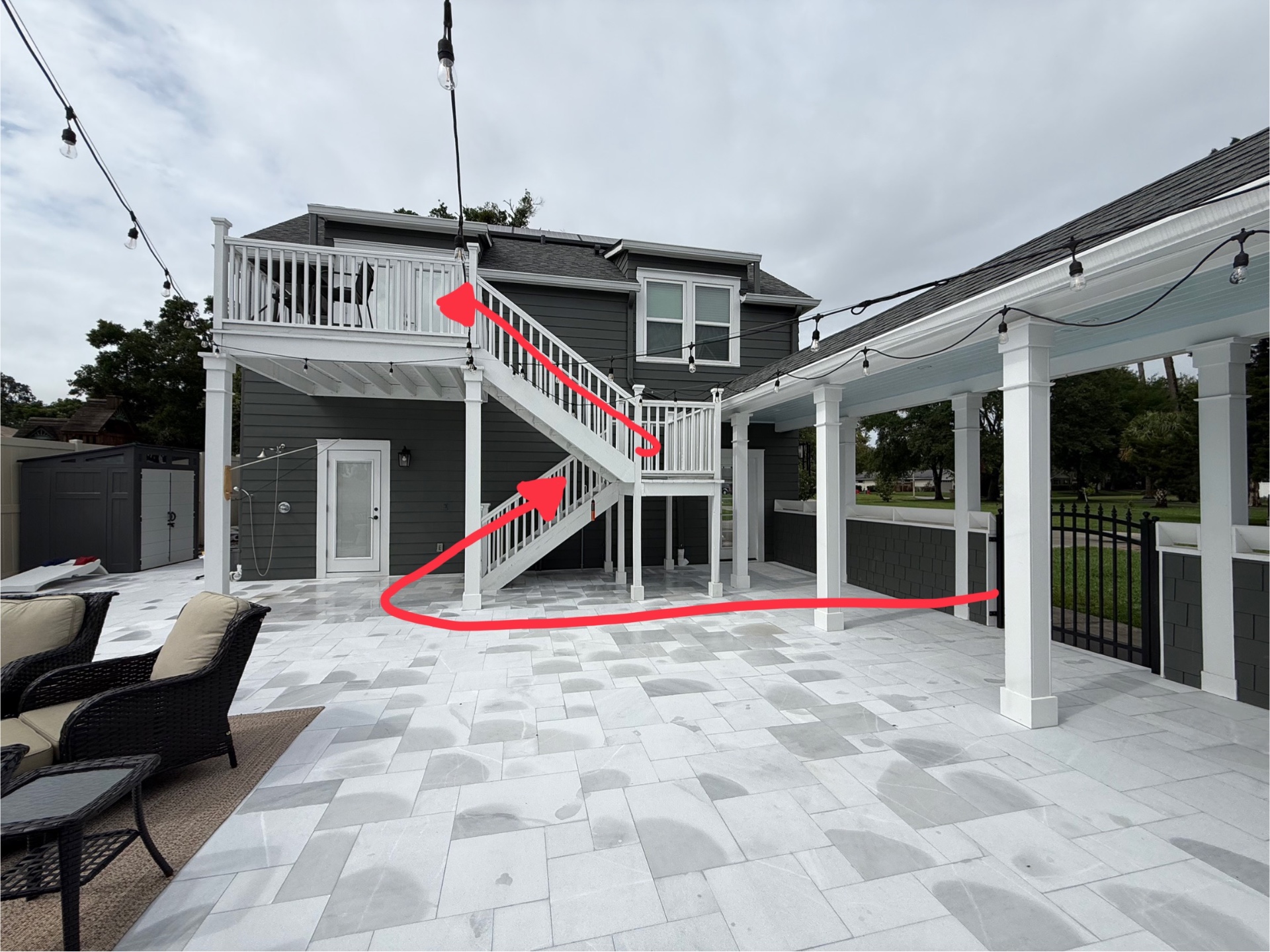 Berry House patio with a marked route leading across to the guest stairs and upper deck